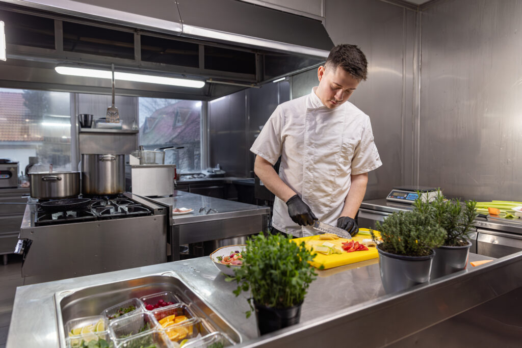 Chef slicing fresh vegetables